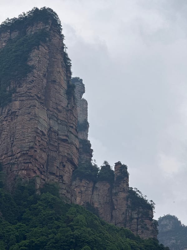 Tourist documents cable car ride through misty Zhonghu mountains