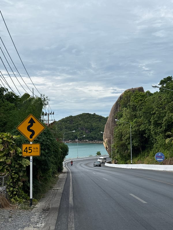 Ko Samui's scenic coastal road winding past turquoise water