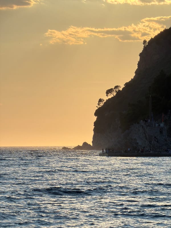 Sunset over rocky cliffs in Petrovac, Montenegro