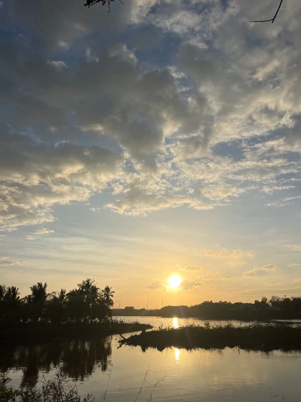 Sunset documented over water in Lhokseumawe, Indonesia