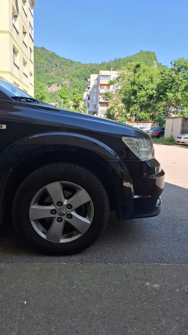 Cars parked near apartment buildings in morning hours