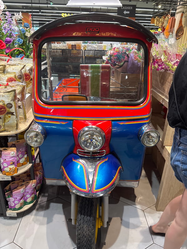 Thai markets display fruits and tuk-tuk in morning hours