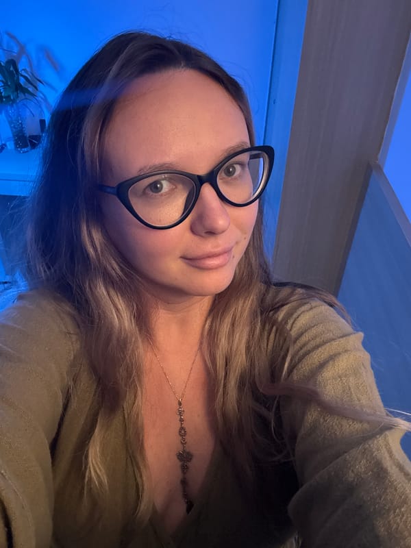 Woman takes selfies in blue-lit room during 11-minute session