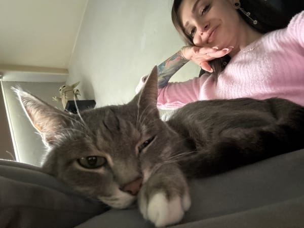 Woman photographed with grey cat in Reutov home