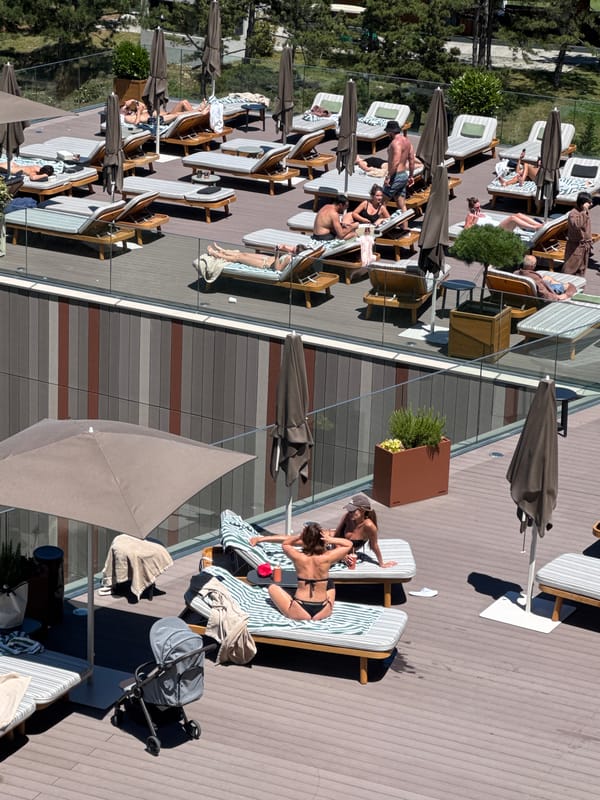 Rooftop pool day above Tbilisi, city and mountains in view