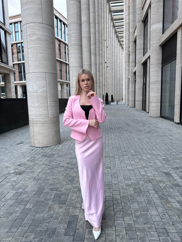 Pink suit, big columns — posing outside modern Saint Petersburg architecture
