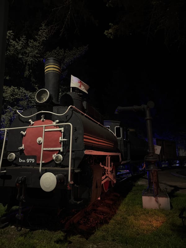 Night visitors photograph historic steam locomotive display in Gyumri