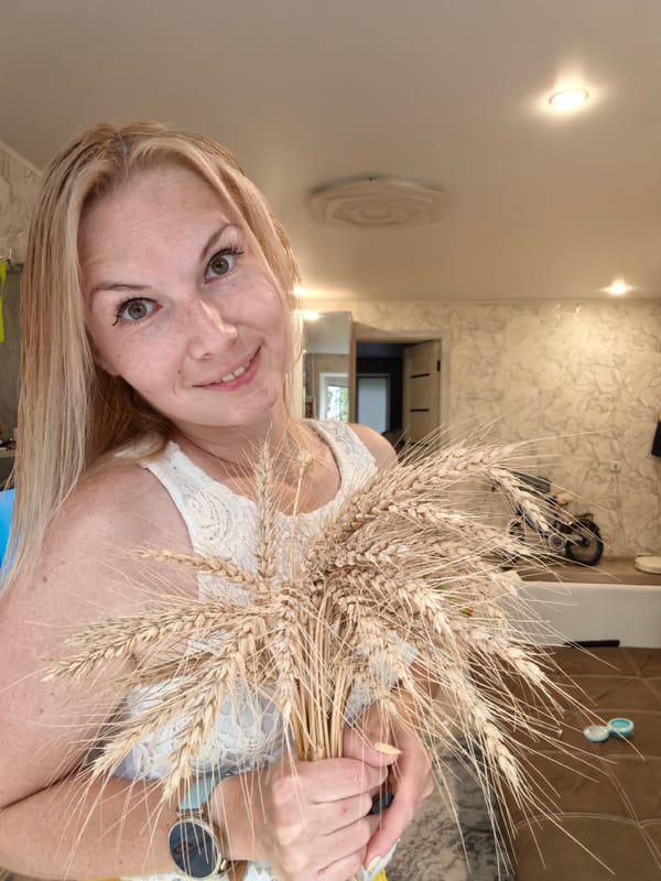 Posing with wheat stalks in a Sterlitamak living room