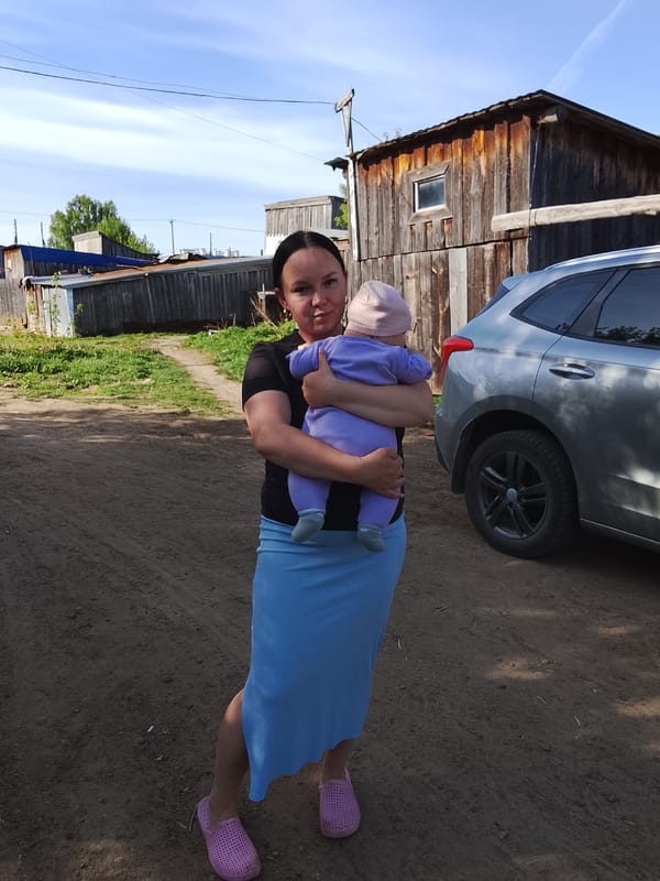 Woman with children observed in outdoor gathering Kuyeda Russia