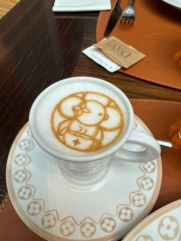 Woman enjoys coffee at luxury Hermès Caffè in Milan