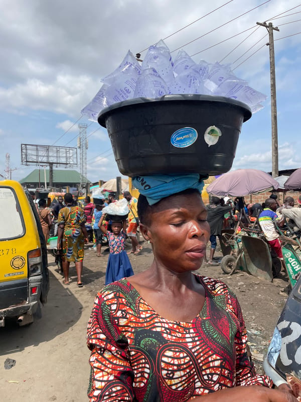 Street vendors and foot traffic in Onitsha's busy market district