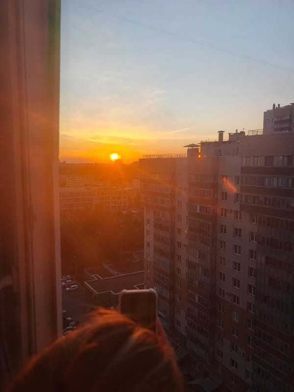 Sunset observed over city skyline from elevated position