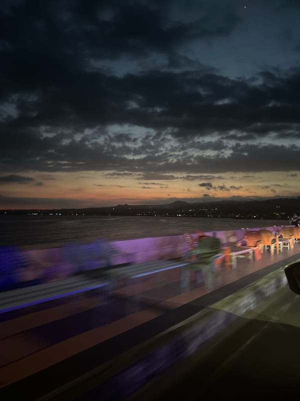 Dusk settles over Bantaeng's waterfront, streets, and stalls