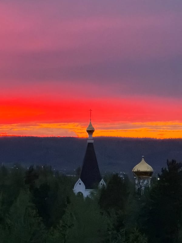 Vibrant sunset observed over church in Ust-Ilimsk, Russia