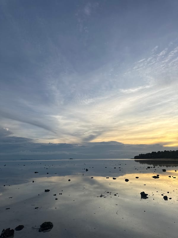 Low tide walk on Koh Phangan's reflective tidal flats