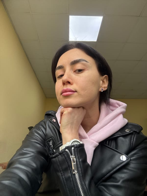 Person in pink hoodie photographed around Tbilisi construction area