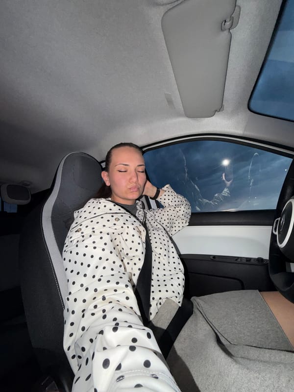 Woman rests in passenger seat during evening in Sofia