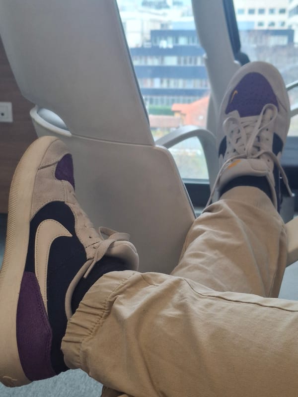 Person in Nike sneakers observed by window in Sofia