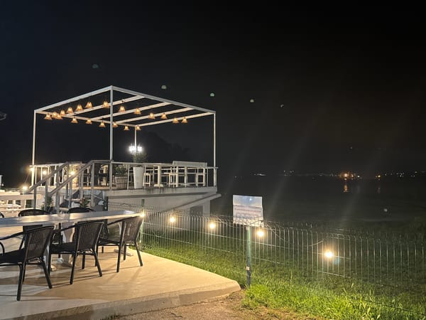 Empty outdoor restaurant patio observed at night