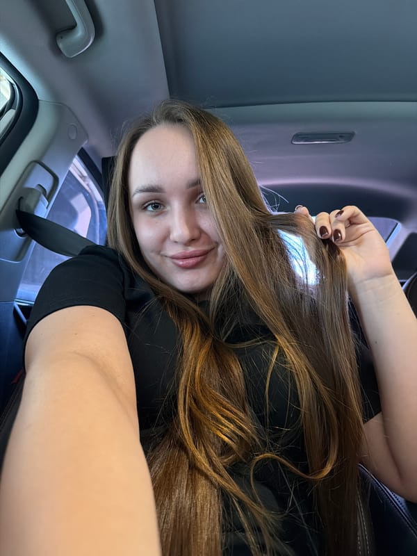 Woman films selfies during car wash in Chaikovsky, Russia