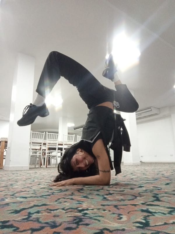 Woman performs inverted yoga pose in Porlamar, Venezuela