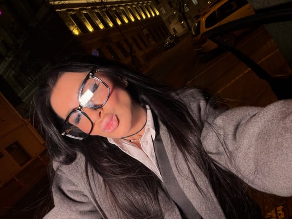 Woman takes nighttime selfie near illuminated building in Voronezh