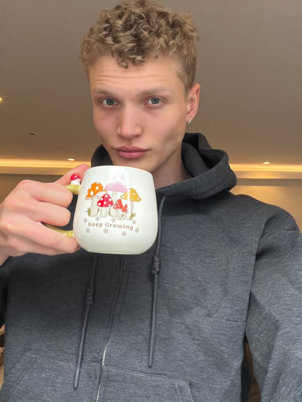 Person holds inspirational mushroom mug in London