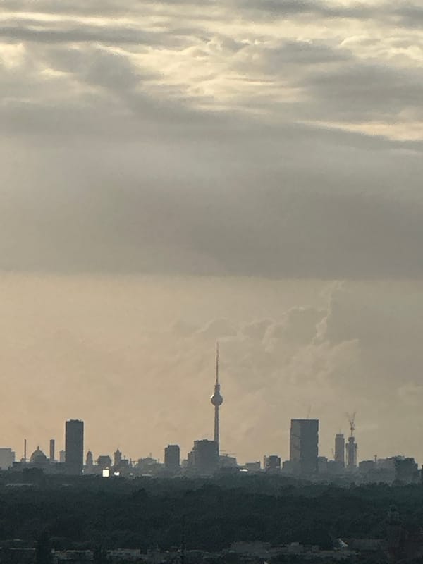 Berlin skyline at sunset, clouds and golden light, July 2026