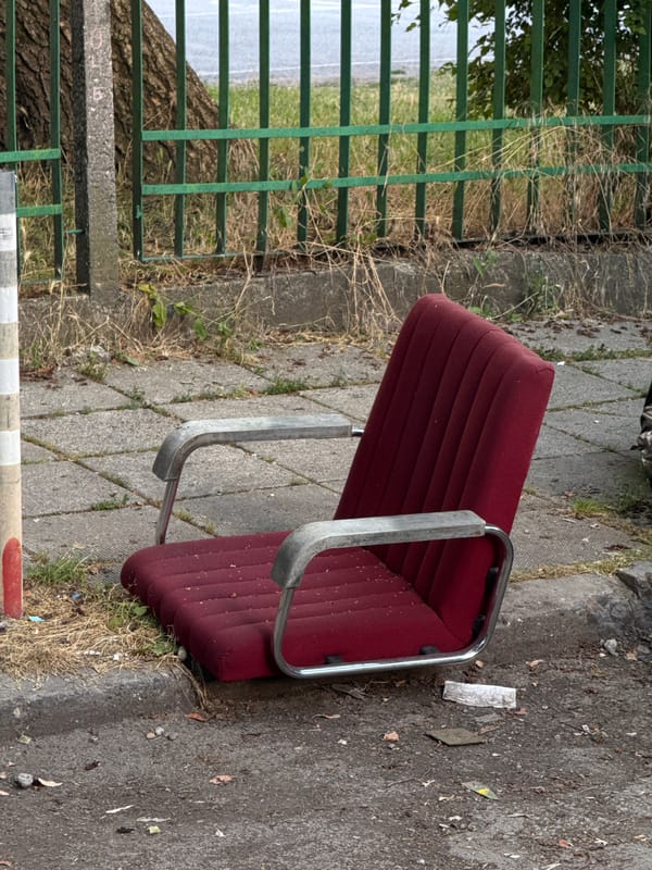 Lone red chair sitting on concrete in Sofia