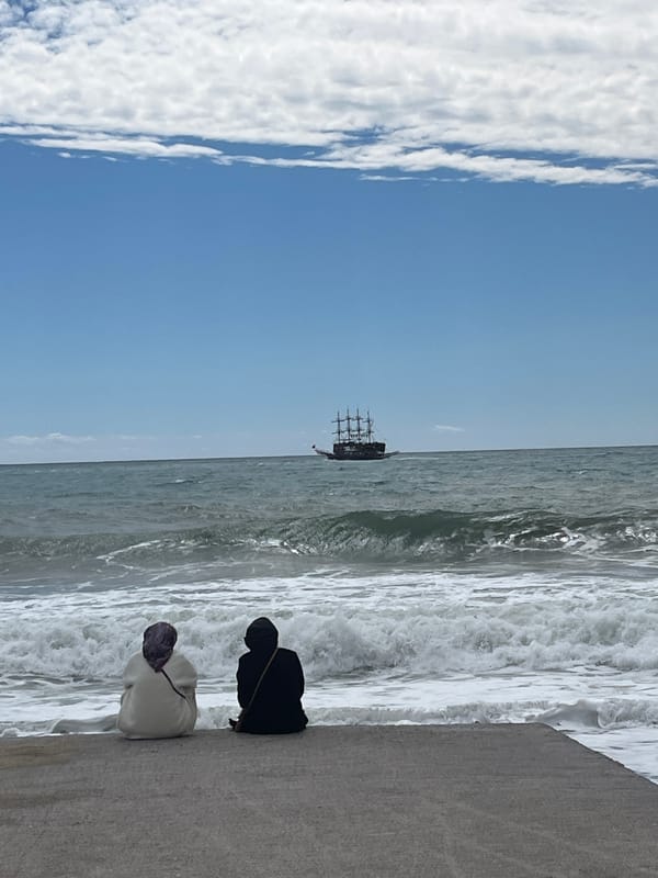 Two people enjoy seaside view in Alanya, Turkey
