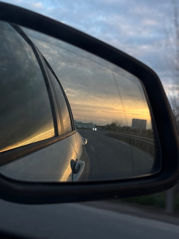 Dawn highway reflection captured in car mirror, Tsaratsovo Bulgaria