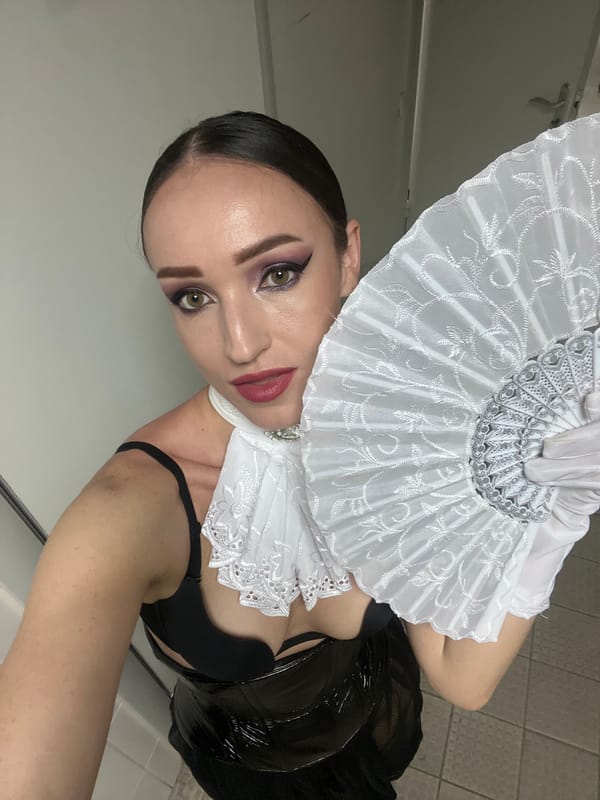 Performer prepares backstage in theatrical costume, captures mirror selfies