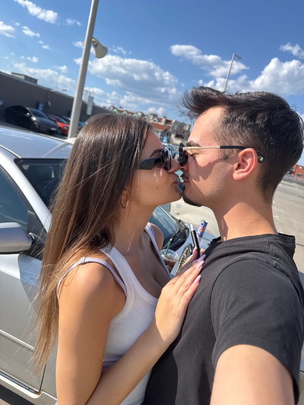 Couple photographed kissing, embracing around Sofia parking lot, escalator