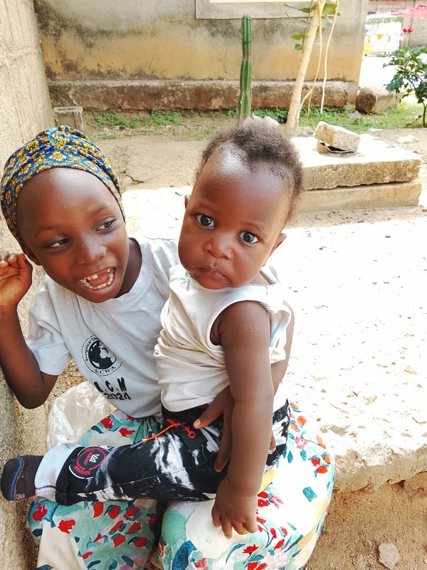 Family gathering captured outside building in Akwanga, Nigeria
