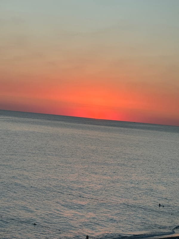 Calm dusk on the Sochi shoreline, sky fading to orange