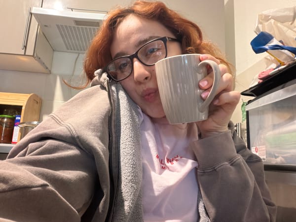 Woman takes morning selfies with coffee mug in Strasbourg