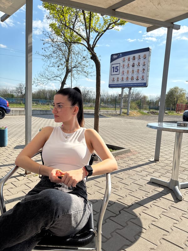 Woman sits at outdoor café in Chirpan, Bulgaria