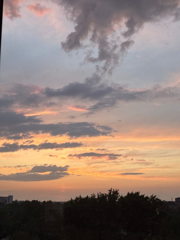 Urban sunset creates vibrant sky display across city skyline