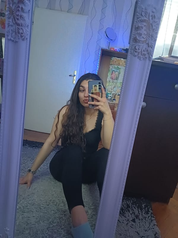 Woman takes mirror selfies at home in Bulgaria