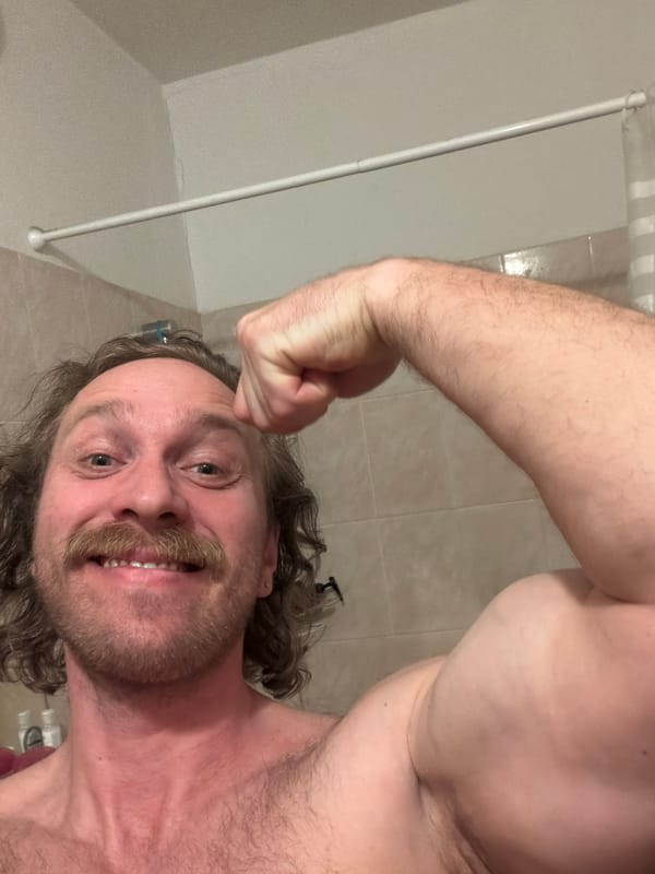 Man poses flexing bicep in Saint Petersburg bathroom