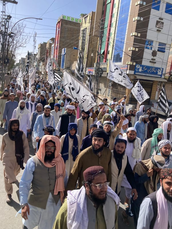 Men march in demonstration through Quetta streets carrying banners