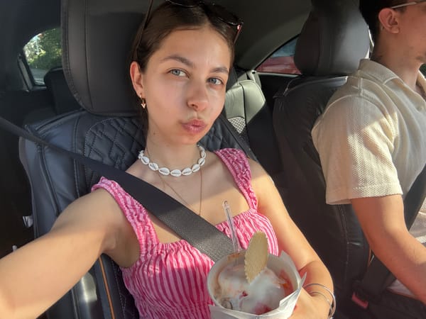 Woman enjoys ice cream, takes selfies in car