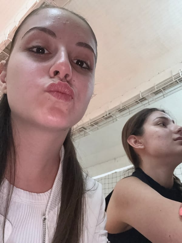 Young women photograph casual gathering in Bulgarian sports hall