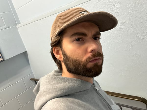 Man in gray hoodie photographed indoors in Montreal