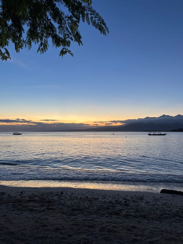 Indonesian beach twilight scene with boats captured by witnesses