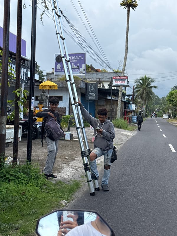 People gather on street handling metal structure in Marga