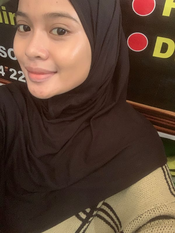 Selfie session in Sungai Meriam, dark hijab, signage backdrop