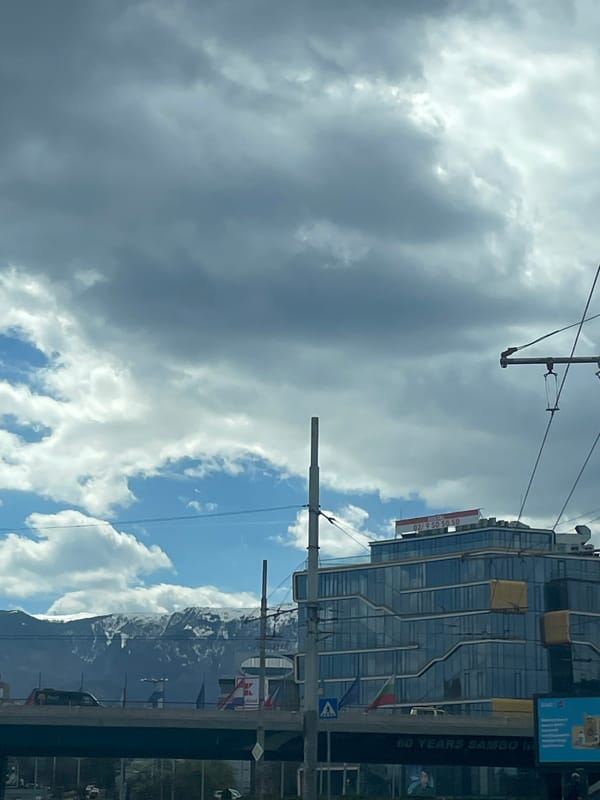 Modern building with phone signage observed in Sofia street scene