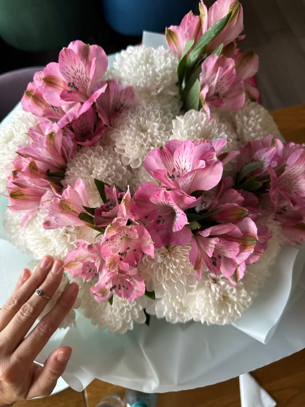 Flowers and Borjomi at a restaurant table in Irkutsk
