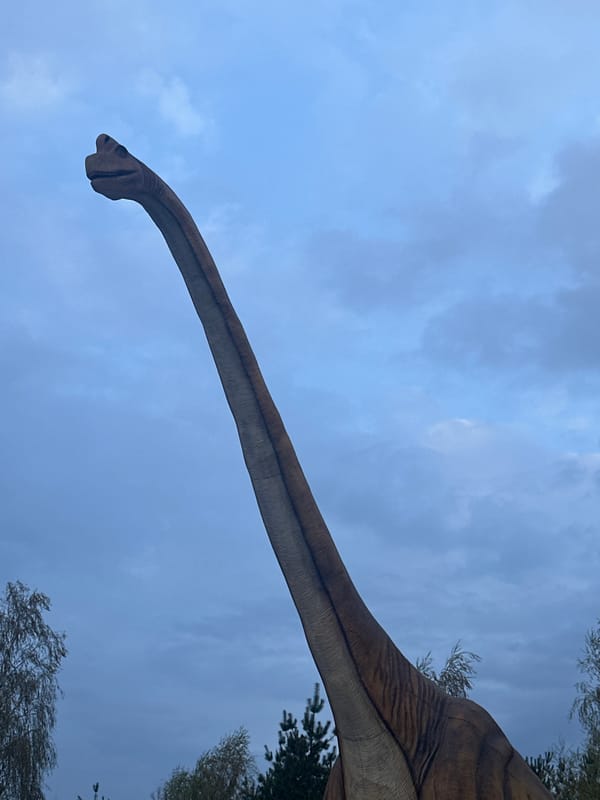 Dinosaur statue spotted against cloudy sky in Khotianivka, Ukraine